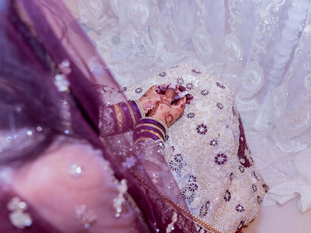 Warm, intimate close-up of a couple in embellished Asian wedding attire