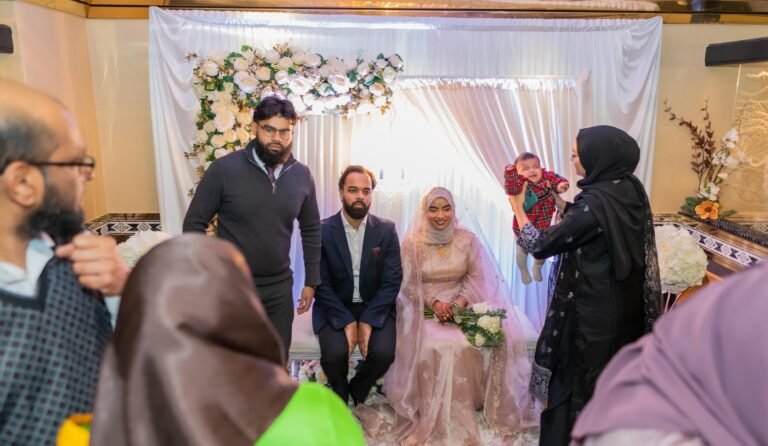 Wedding party gathered on a decorated stage during the ceremony