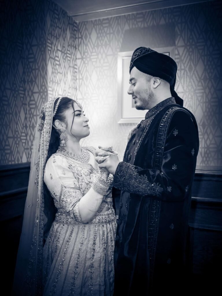 Black and white portrait of a bride and groom facing each other